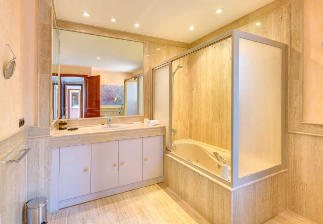 Spacious and bright bathroom Spacious wooden bathroom with glass shower screen