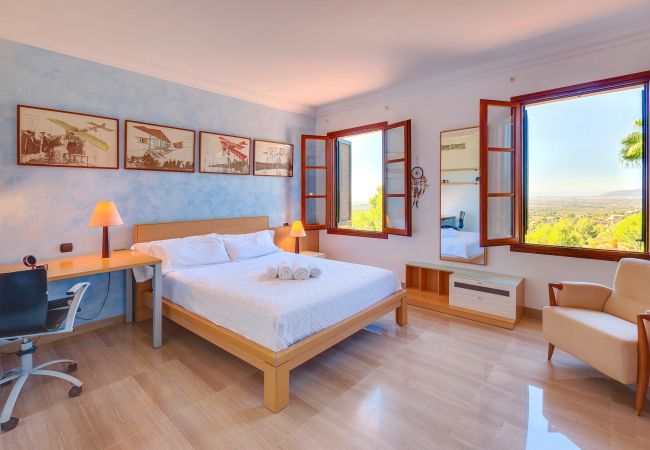 Villa Tierraseca Bunyola  Bedroom with a desk and beautiful views.