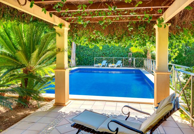 Fenced pool with a shaded area. Fenced pool with a shaded area.