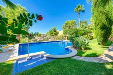 Pool with grass and a flower garden.