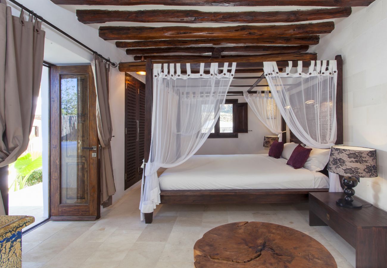 Double bedroom with beams and beautiful garden views Villa Ibiza Bedroom beams villa Luxury Ibiza Holidays